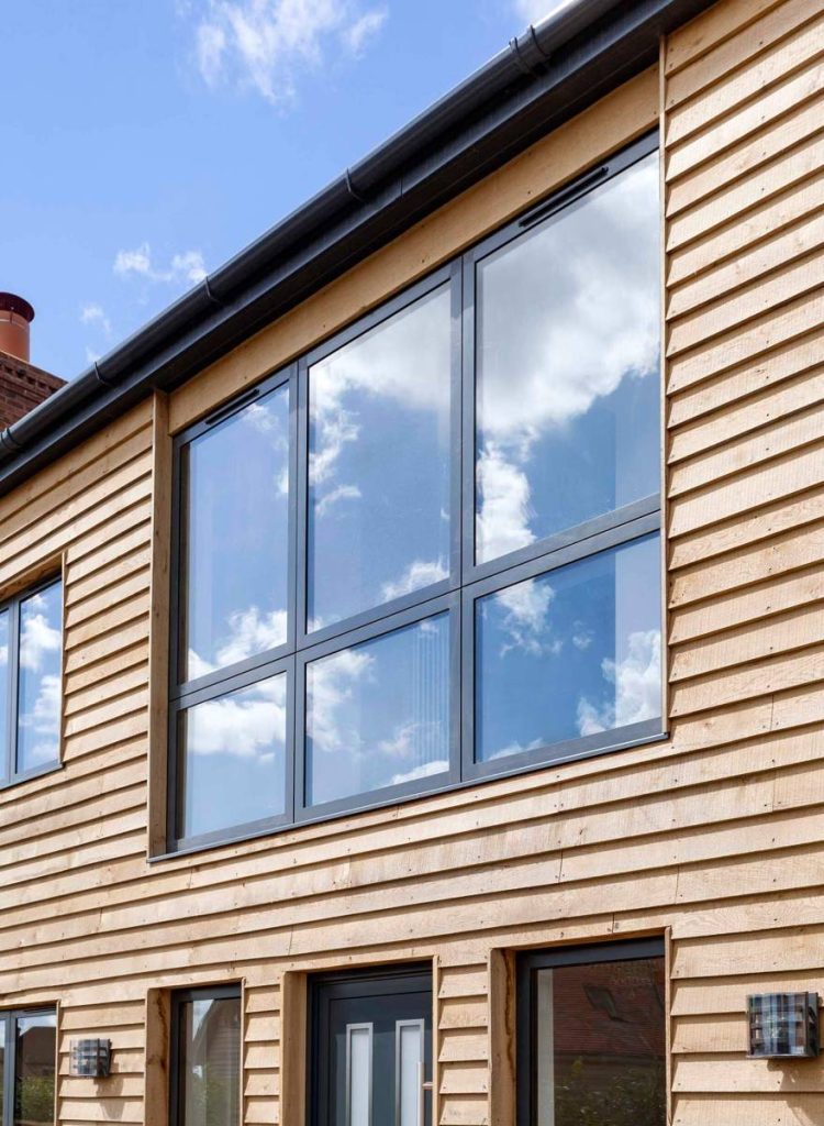 black aluminium windows on a wood style house